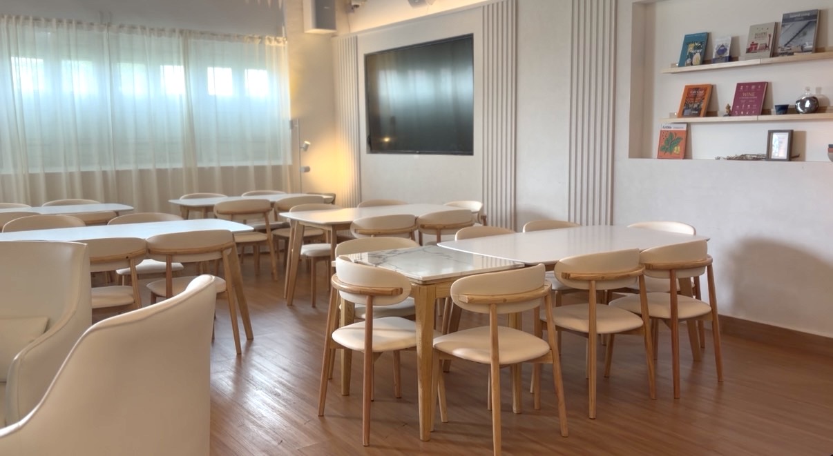 BYD Cafe dining area with marble tables, oak chairs and warm cove lighting